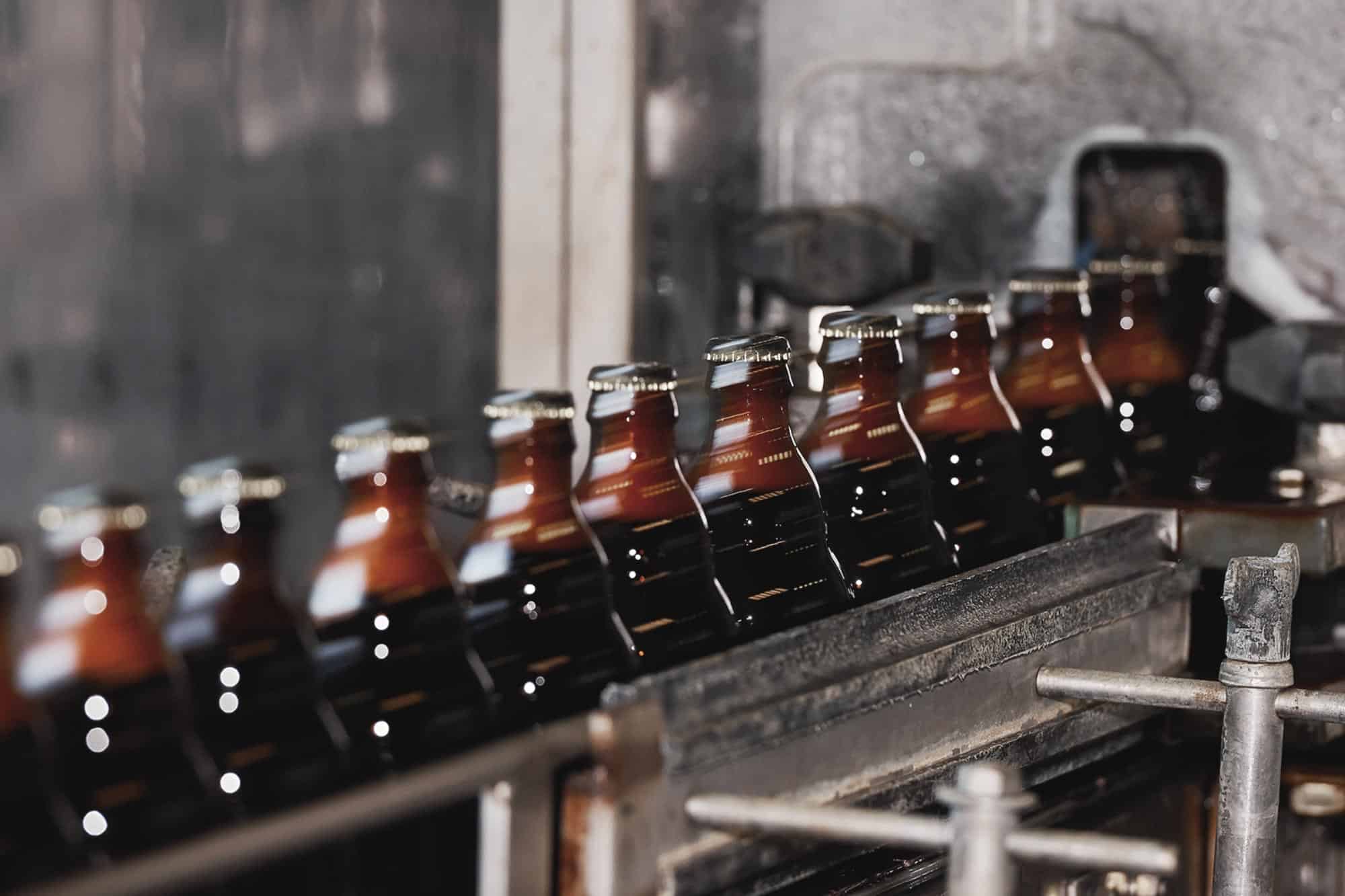 Gulden Draak bottles moving along the brewery production line